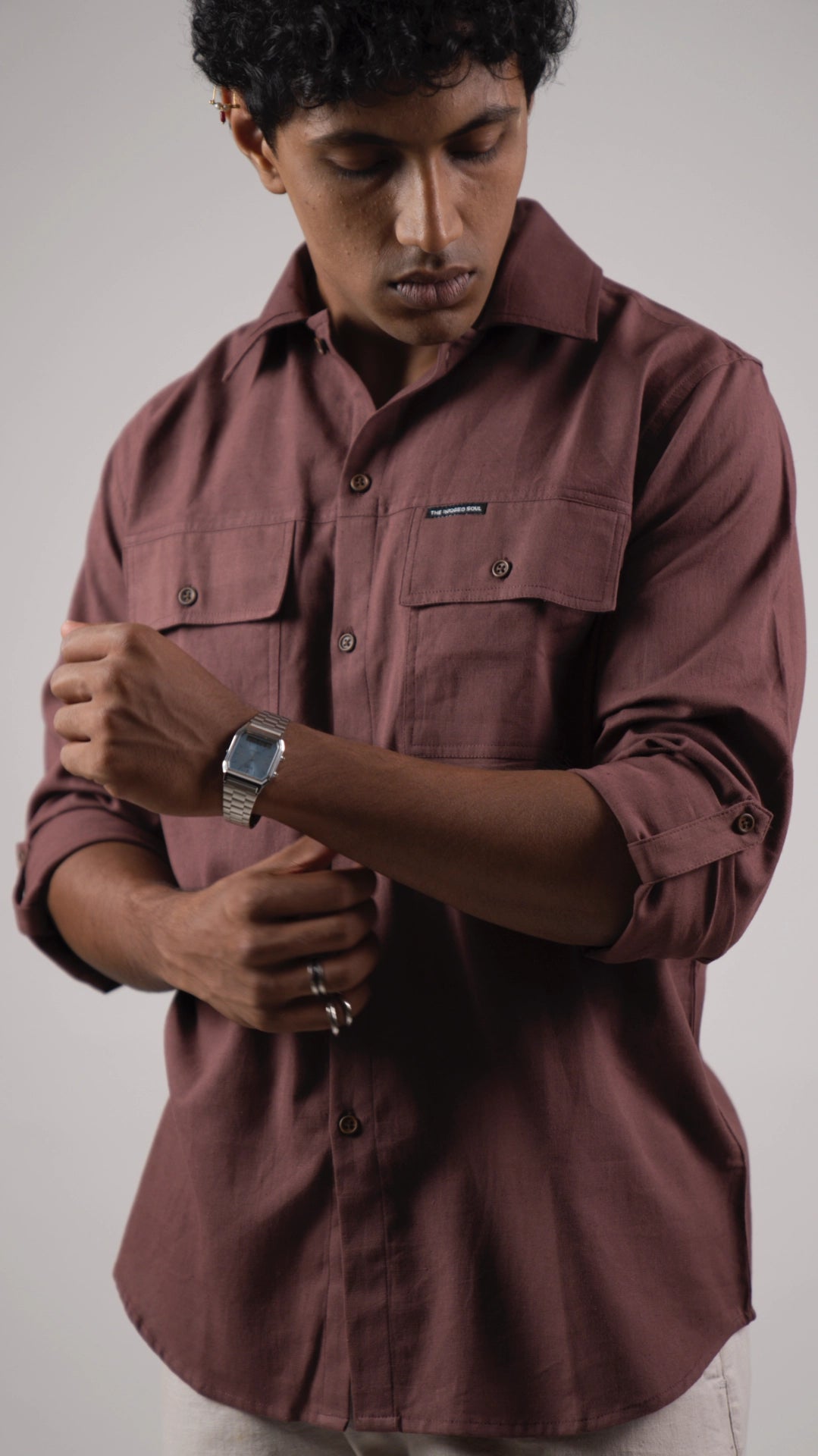 Model with sleeve rolled up adjusting watch