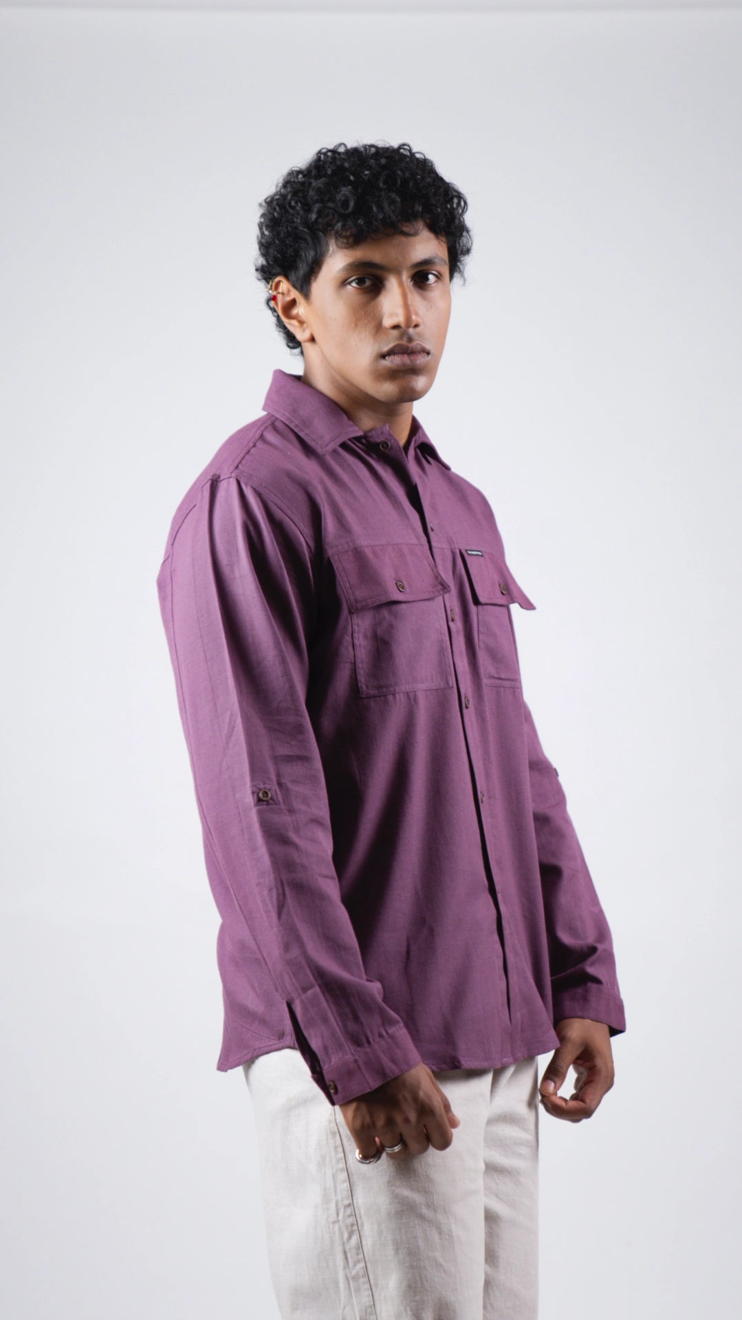Man wearing a purple shirt against a white background