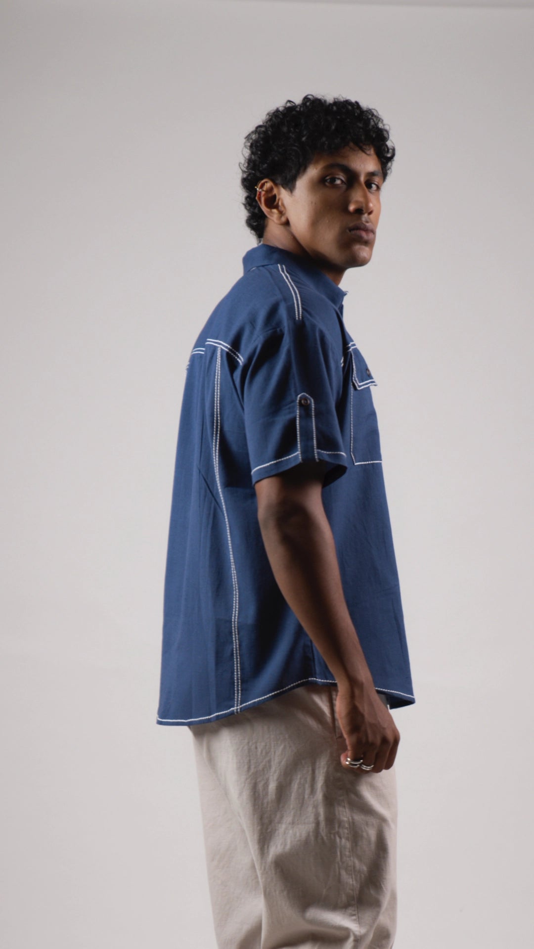 Side view of a man wearing a blue cotton linen half-sleeved shirt