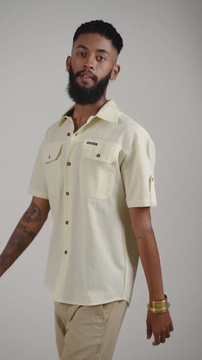 Video of a man posing in an alabaster white half sleeved cotton linen shirt