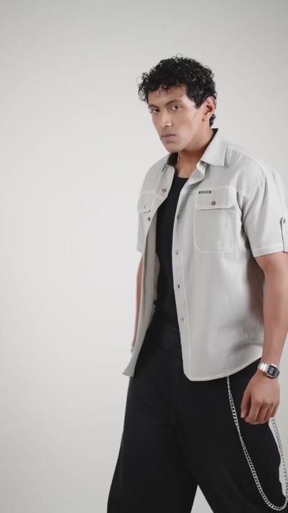 Video of a man posing in a cotton linen gray half sleeve shirt