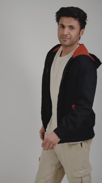 Video of a man posing in a woven cotton hoodie with rust accents
