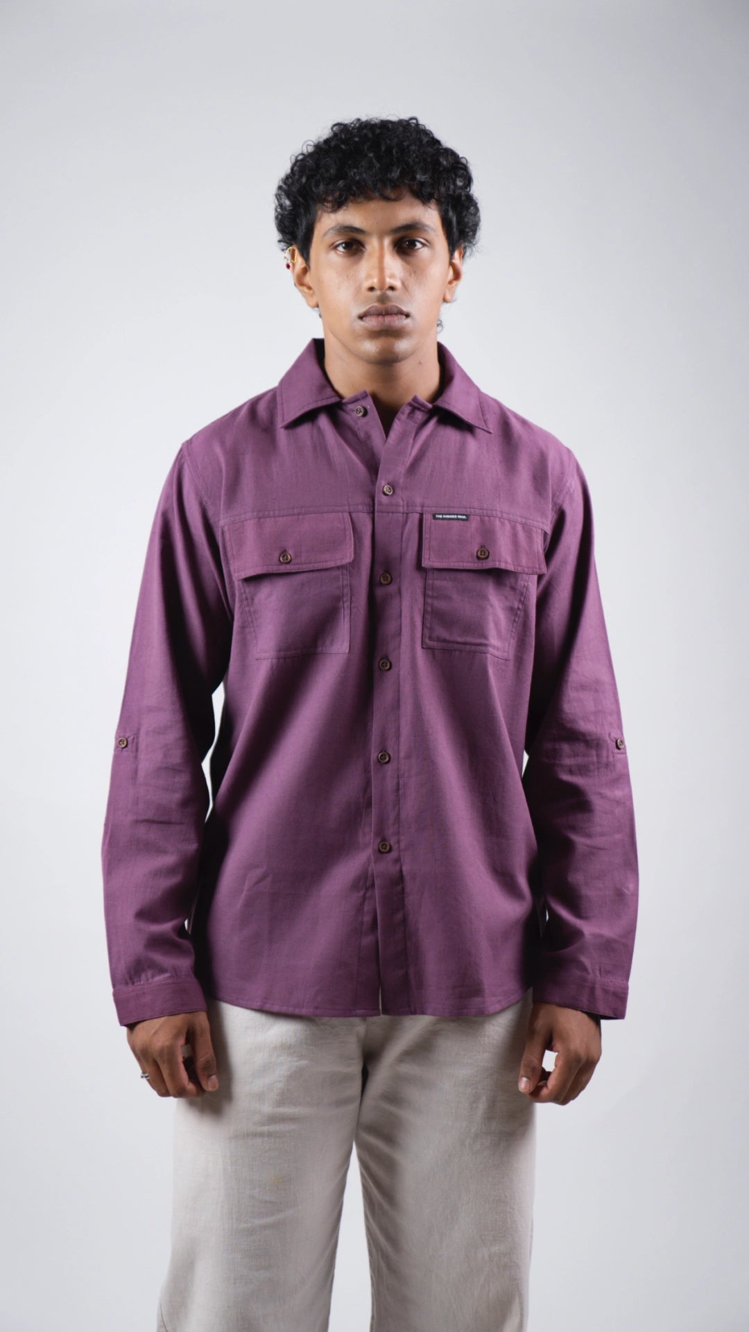 Man wearing a purple shirt against a white background