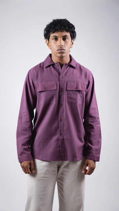 Man wearing a purple shirt against a white background