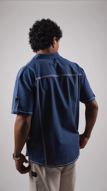 Back view of a man wearing a blue cotton linen half-sleeved shirt