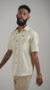 Video of a man posing in an alabaster white half sleeved cotton linen shirt
