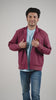Video of a man wearing a deep garnet-coloured cotton twill jacket on a light shirt and blue jeans