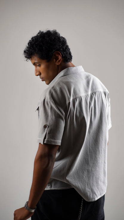Back view of a man wearing a gray cotton linen half-sleeve shirt